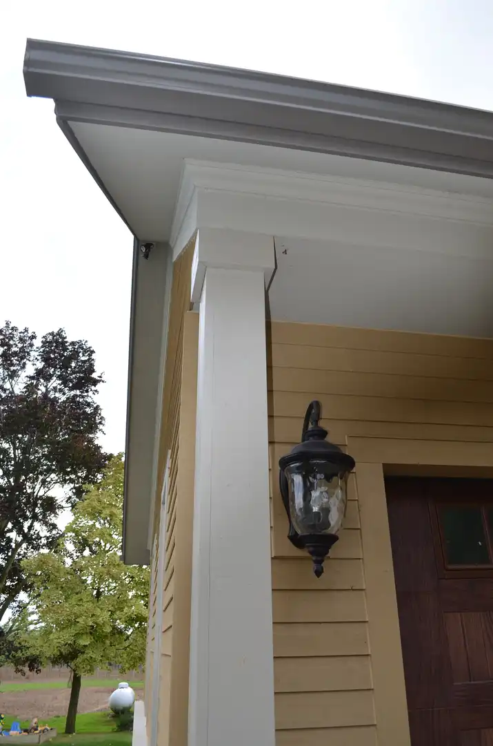 Exterior light and support post on garage